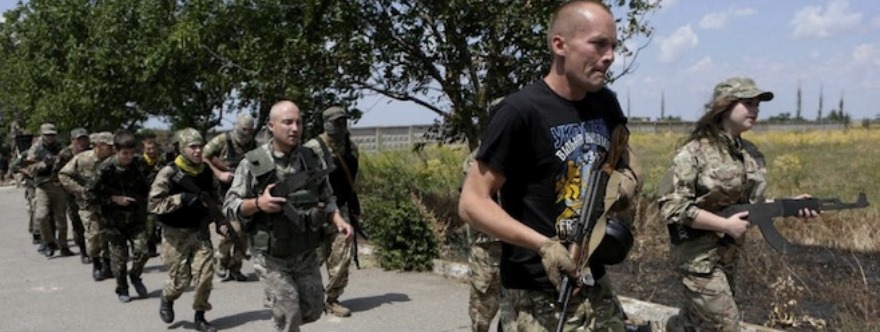 In this photo taken on Thursday, June  25, 2015, members of a self-defense unit for Odessa, Ukraine, carry out exercise drills in a location outside the Odessa, Ukraine. Odessa lies more than 500 kilometers (300 miles) west of the front line in east Ukraine, where government troops are mired in a war of attrition against Russian-backed separatists. (AP Photo/Sergei Chuzavkov)
